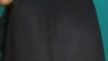 Desi female in a long black skirt exposes legs and boobies in sex show