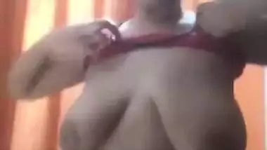 Desi woman puts on clothes in front of cameraman filming porn video