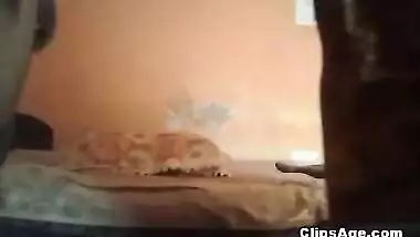 Indian guy making his wife lie back as he makes the video of himself fucking her