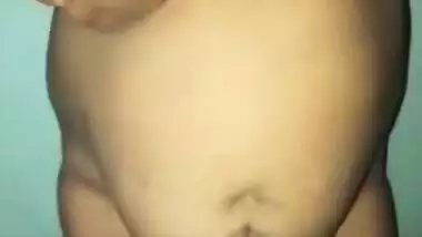 Desi woman with sexy fat tummy and big tits spreads pussy in XXX video